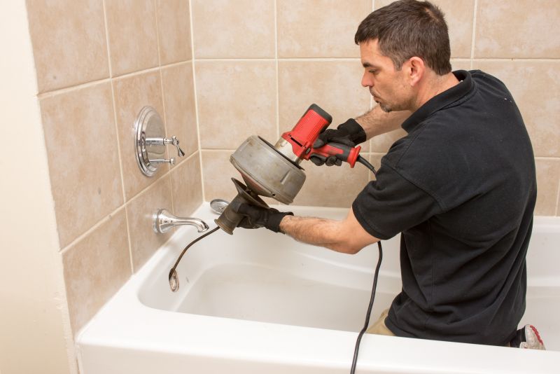 Plumber Using Auger